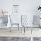 Chaise de salle à manger grise sans accoudoirs, avec dossier capitonné à motif quadrillé et clouté, et pieds en métal argenté.