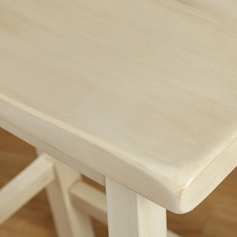 Tabouret de bar rustique sans dossier en hévéa, hauteur comptoir, avec assise en forme de selle
